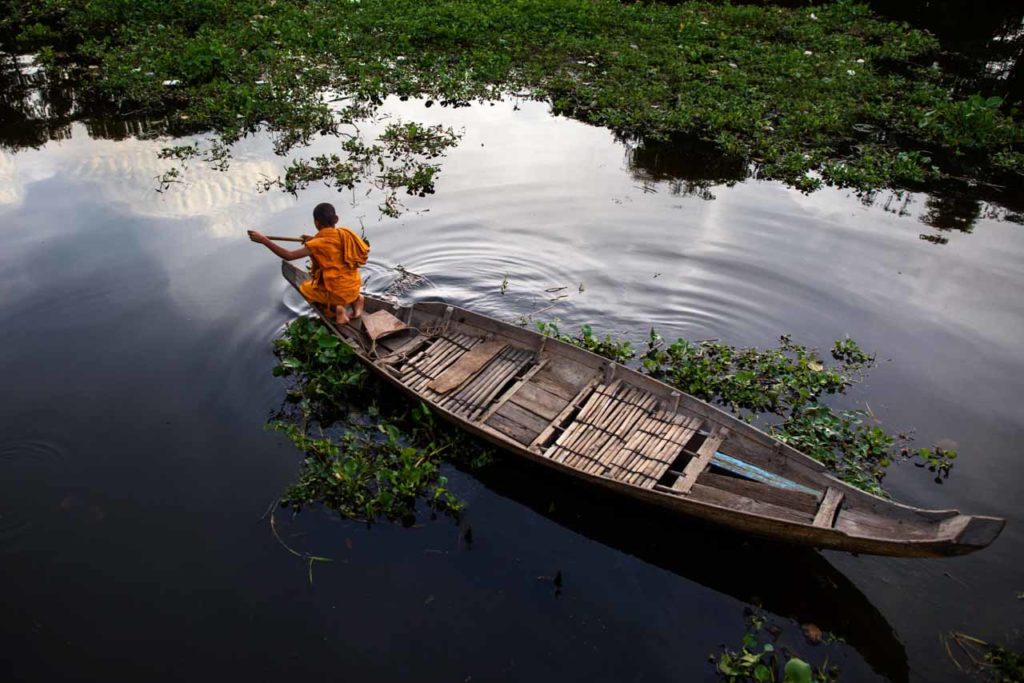 Monk on a boat on Tonle Sap Lake