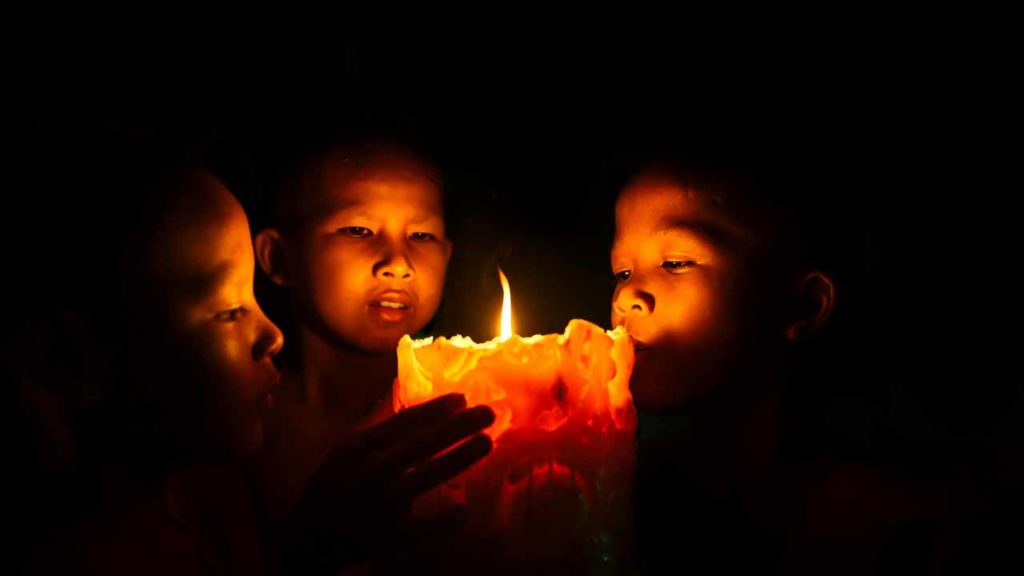 Monk playing with a candle