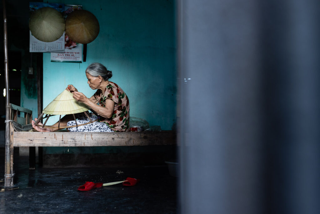 Vietnamese woman making conical hat