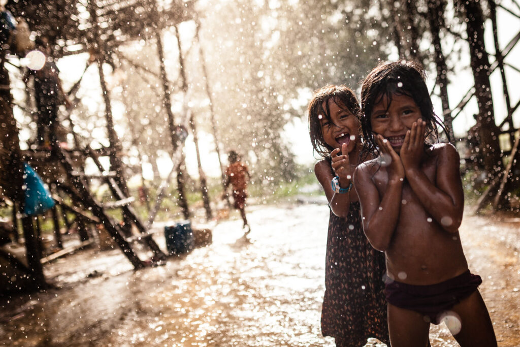 Kids playing in the rain in Cambodia