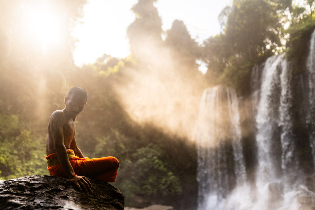35mm lens shot of a monk before Kulen Waterfall, using the rule of thirds to highlight context.