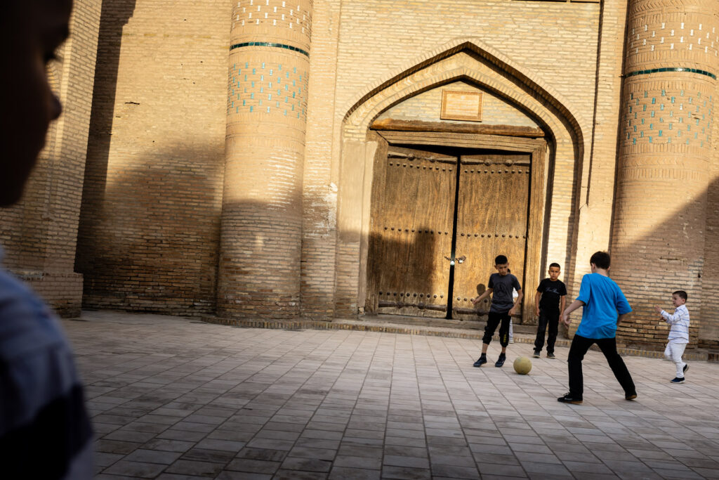 Kids playing football in the street of Khiva