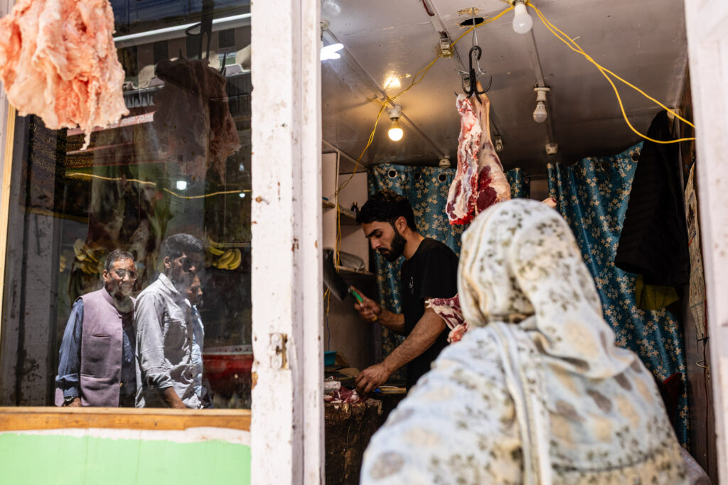 Reflection of a street scene in a window in India